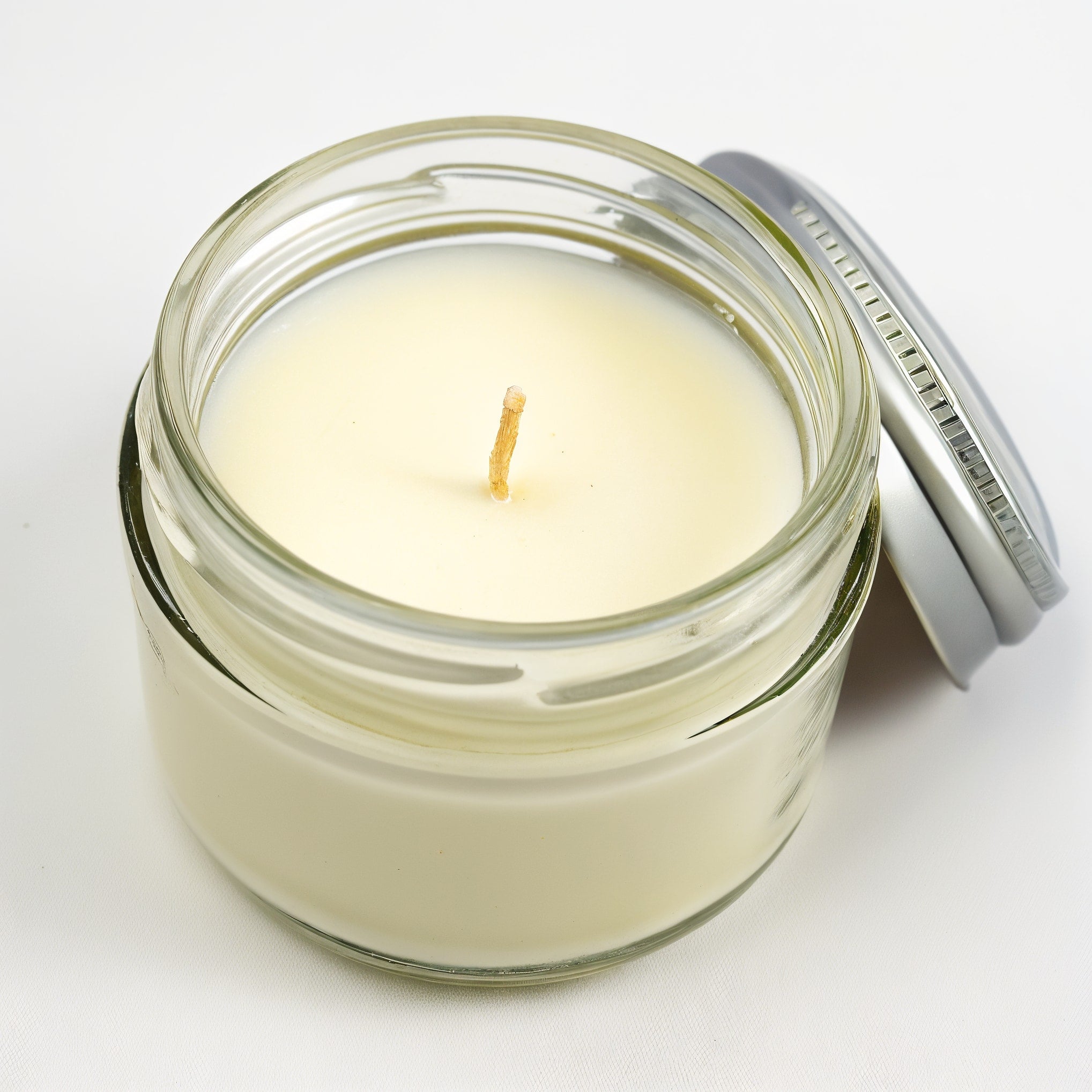 Naldony Lemon Verbena Soy Candle — front view of clear glass jar with lemon accents