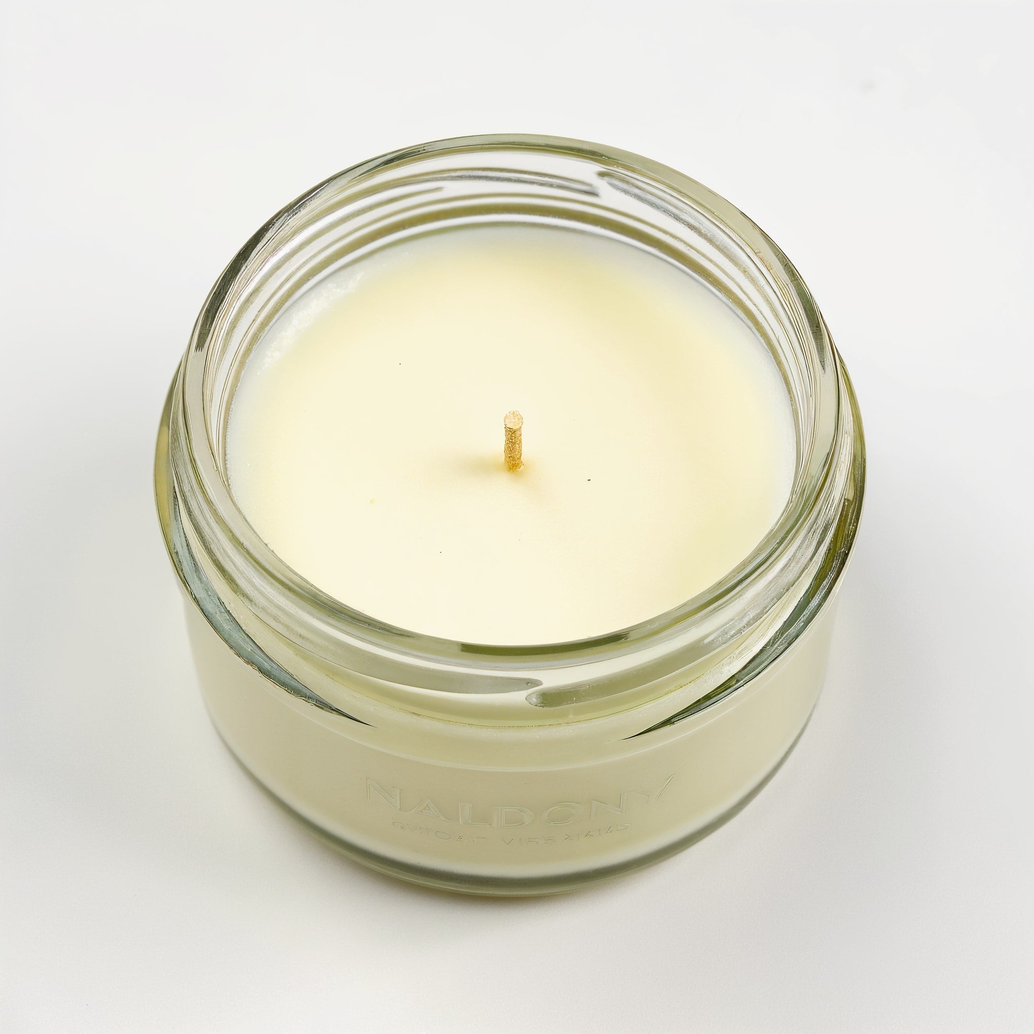 Naldony Lemon Verbena Soy Candle — bottom view of clear glass jar base