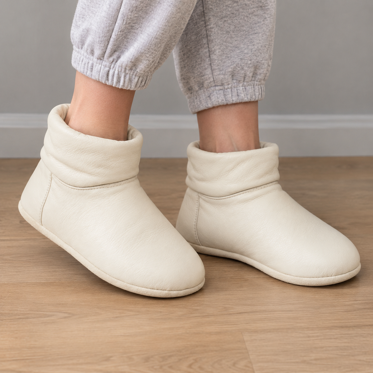 Side view of cream leather ankle boot.