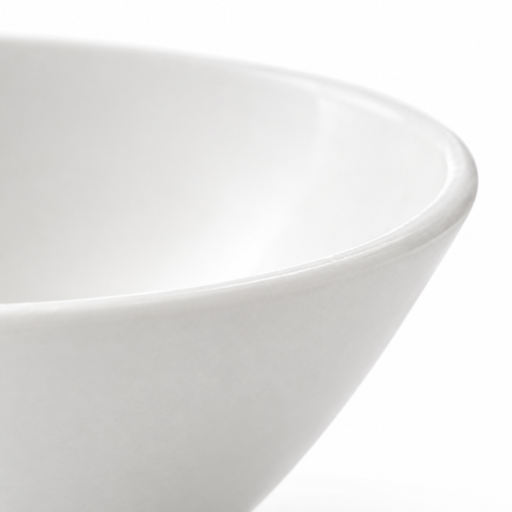 White serving bowl on a plain background.