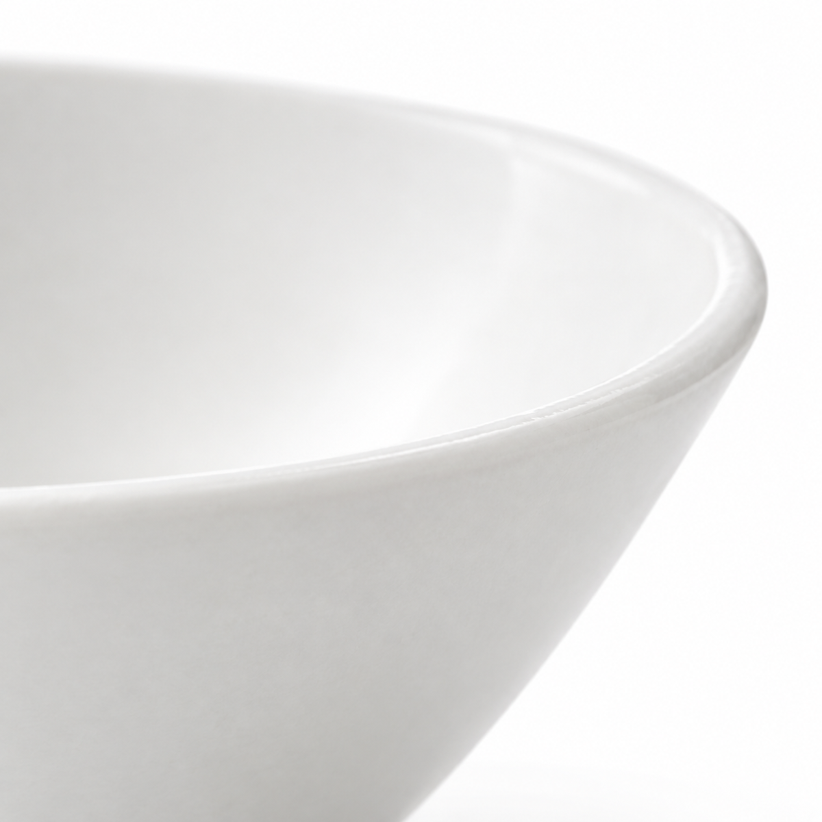 White serving bowl on a plain background.