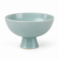 Sky blue ceramic pedestal bowl side view.