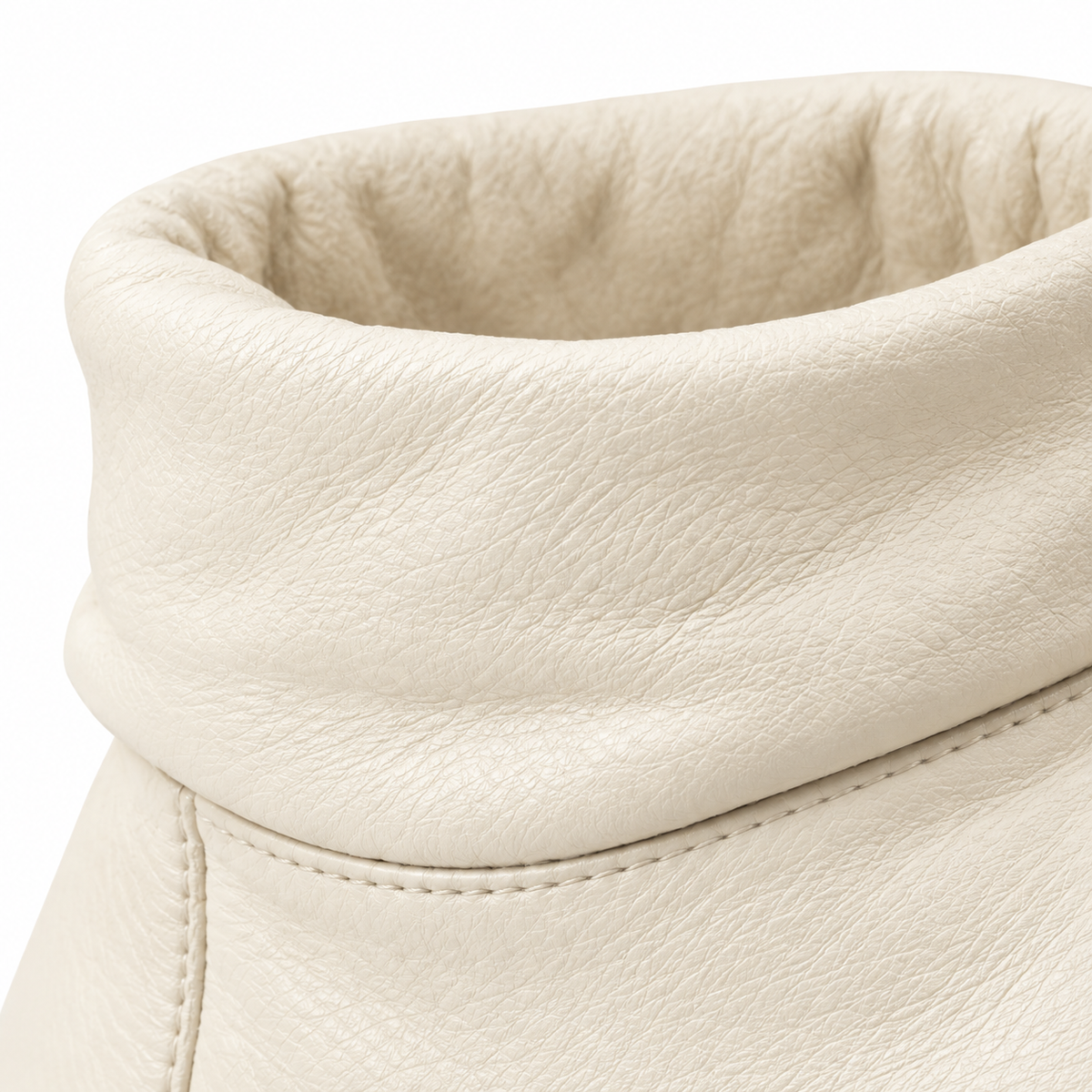 Sole view of cream leather ankle boot.