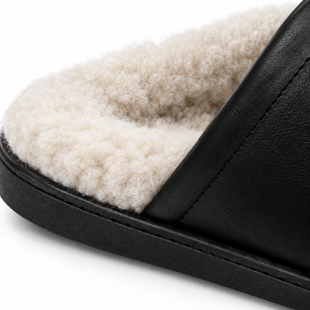 Naldony slipper in black with plush faux fur lining, angled view.
