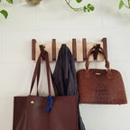 Wall-mounted wooden piano coat rack with flip-down hooks