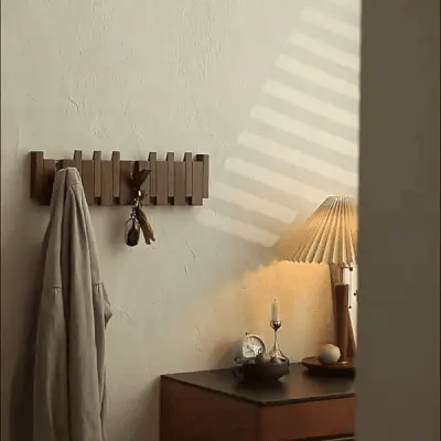 Wall-mounted wooden piano coat rack with flip-down hooks