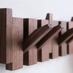 Wooden wall mounted coat rack with flip-down piano key hooks